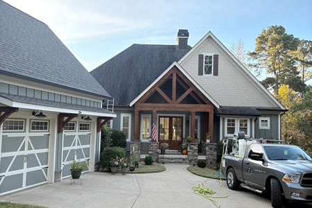 Low pressure roof soft wash removing algae from shingles